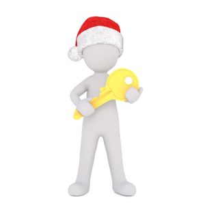 man with christmas hat and golden key