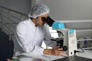 Chemist looking in microscope