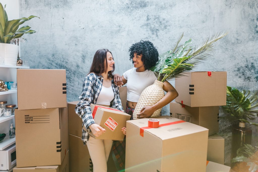 Woman packing up things in boxes to relocate