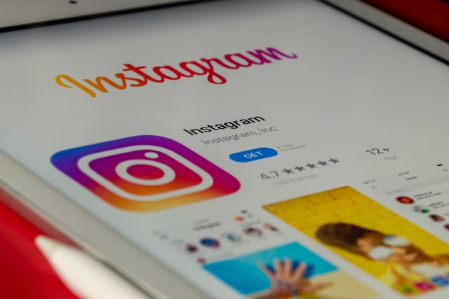 Instagram logo with few pictures on the screen
