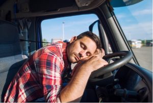 A truck driver sleeping while driving.