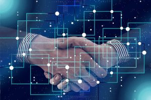 Two men shaking hands for Blockchain technology.
