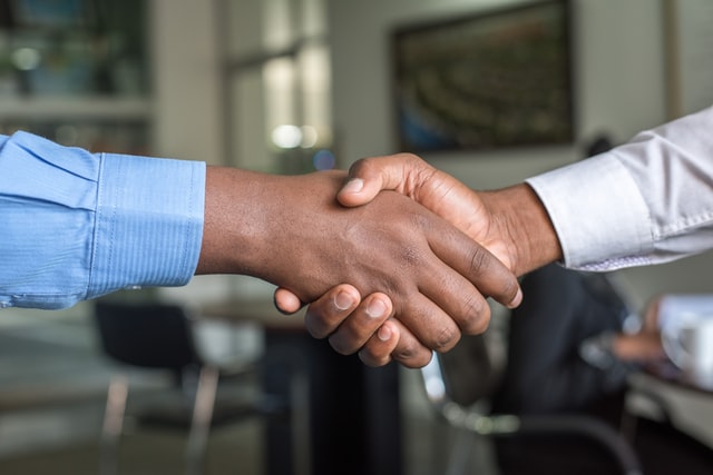 HR shaking hands with the remote employee.