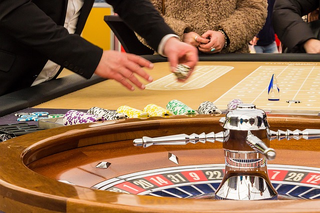 Players playing roulette game in casino.