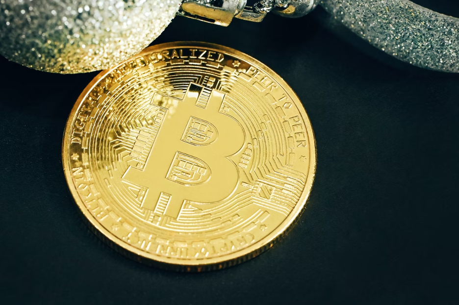 A golden bitcoin placed on the table.