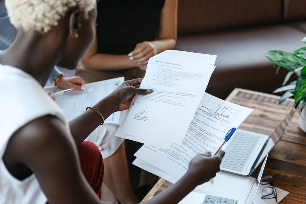 A woman looking into few documents.