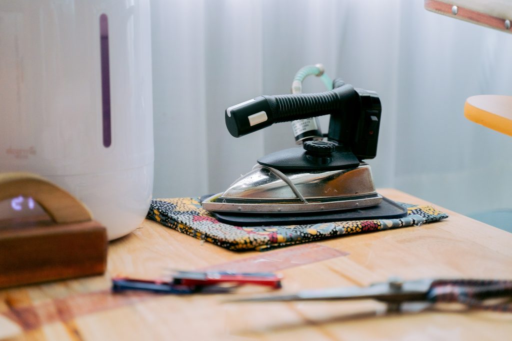 An iron placed on a folded cloth.