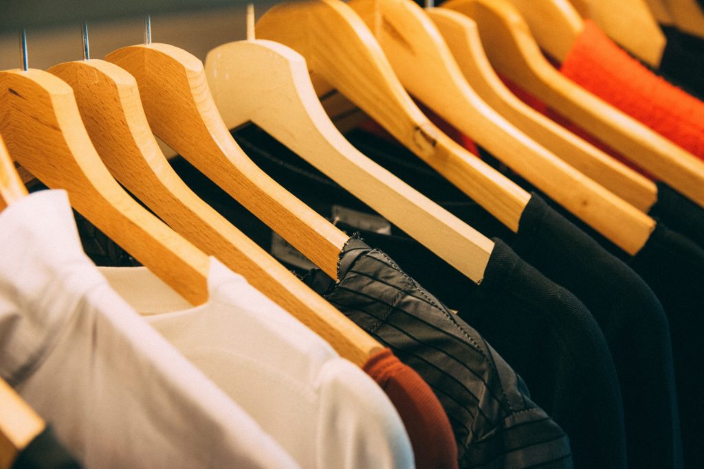 Many T-shirts hanged in the hangers.