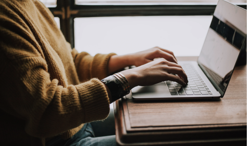 A woman typing on her laptop.