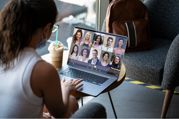 A woman attending an online meeting.