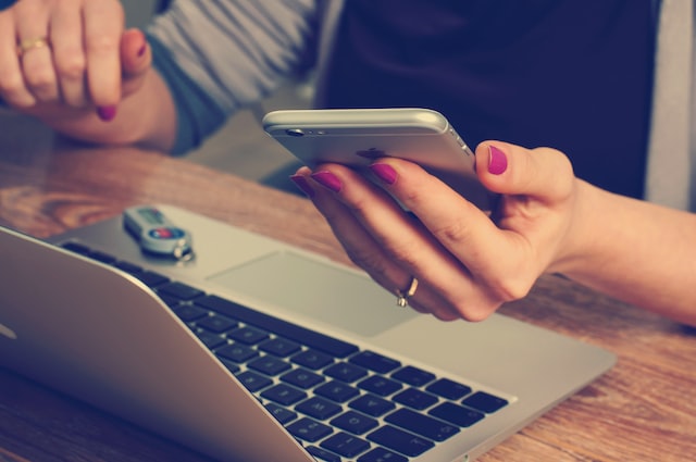 A woman looking into her phone and mobile.