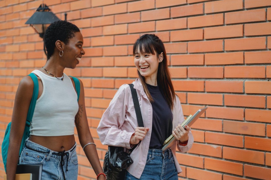 Two girls chatting while walking.