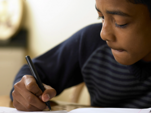 A boy writing an essay.