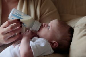 A baby drinking goat milk.