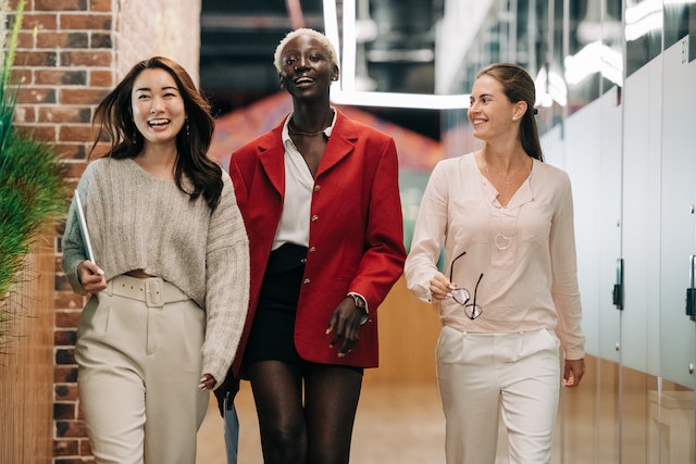 Three women walking on the street.