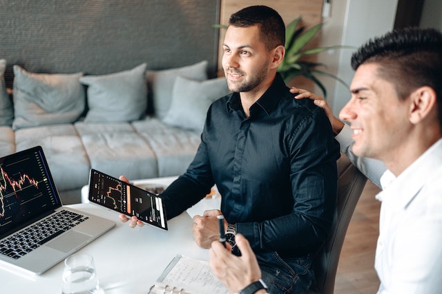 Two men looking at the screen.