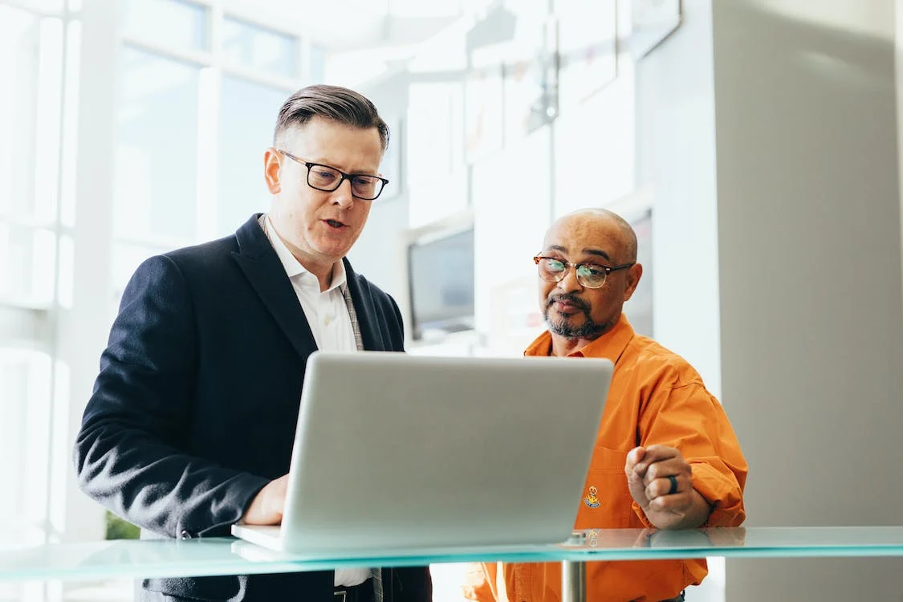 Two men looking at the screen.