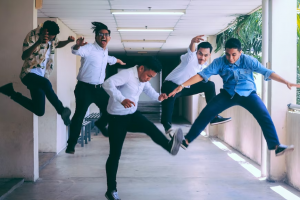 Group of men jumping.